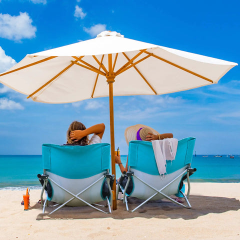 Low Beach Chair With Mesh Back And Cup Holder, Foldable Camp Chair For Outdoor Use on sandy beach under umbrella