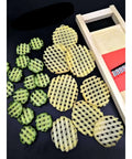 Wave Waffle Crinkle Cutter set: beige round lattice discs for potatoes; cucumber slices and a wooden box beside.