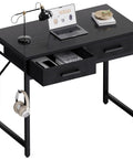 32 Inch Compact Computer Desk With Two Drawers For Small Spaces Black Ideal For Bedroom Study Home Office Writing Table Space Saver And Organization Perfect For Tiny Rooms And Study Nooks with laptop and lamp.