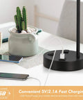 USB Powered Modern Table Lamp With Built In Outlet Industrial Farmhouse Bedside Desk Light For Bedroom Office Living Room Black Finish Space Saving Design Bulb Not Included, showing base with charging phones.