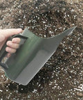 Hand using Green Plastic Garden Shovel All In One Plant Scoop For Transplanting Digging Potting Soil Turning And Sifting