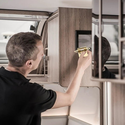 Person installing Heavy Duty Self-Closing Spring Hinges, Five Pack, One Half Overlay, Semi-Hidden Steel Cabinet Door Hinges on RV cabinet