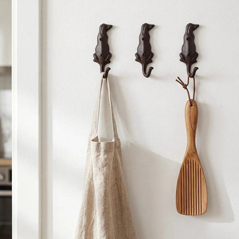 Kickass Cast Iron Dog Tail Hooks, Straight Up 4 Pack Wall Mount Leash Holders With Screws and Anchors, rustic hooks holding a bag and wooden spatula.