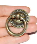 Close-up of a vintage-style bronze drawer ring pull in hand, part of 8-Piece Bronze Drawer Ring Pulls Set With Screws For Dresser Cabinet Wardrobe.