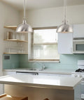 Kira Home Belle 9" Modern Industrial Pendant Light with Dome Shade, Petit Retro Metal Silver Hanging Light, Brushed Nickel Finish in kitchen setting.