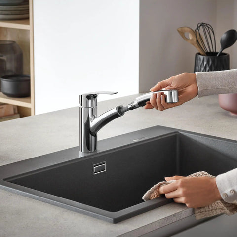 Person using Eurosmart Dual Spray Pull Out Kitchen Faucet With Sprayer 1.75 GPM Chrome Durable Stainless Finish over a sink.