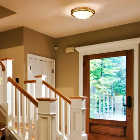 Gold 2-Light Flush Mount Ceiling Light With Milk Glass Shade, Brass Finish, installed in a modern foyer.