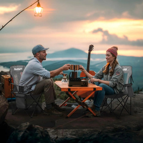 Outdoor campers using 2 Pack Foldable Outdoor Camping Chairs With Built In Cooler Pouch Ultra Comfy Cushioned Seats Mesh Backrest And Cup Holder Pocket In Grey for a sunset picnic.