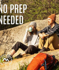 Two campers enjoy a break sitting on a rock with a backpack nearby, under 'No Prep Needed' text.