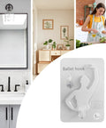 Kickass Sticky Wall Hooks Featuring A Snazzy Ballet Design Deliver Rock Solid Hold For Quick Organization And Snazzy Room Accents Without Damage Or Drilling Required showing white ballet hook packaging in a stylish kitchen.