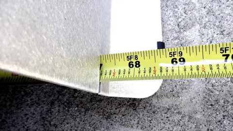 Close-up of Heavy Duty 2 Wheel Alignment Tool For Camber Caster And Toe measuring 68 to 69 inches with a tape measure.