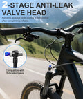 Pro Grade High Pressure Bike Shock Pump With Gauge, 300 PSI Max, attached to Schrader valve on mountain bike fork, scenic backdrop