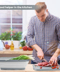 Man using 9 In 1 Collapsible Cutting Board With Colander For Camping And Outdoor Kitchens in a kitchen setting