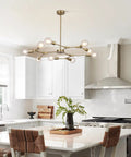 Lit Brushed Brass Sputnik Chandelier With Adjustable Hanging Arms Industrial Flush Mount Ceiling Light Fixture in modern kitchen.