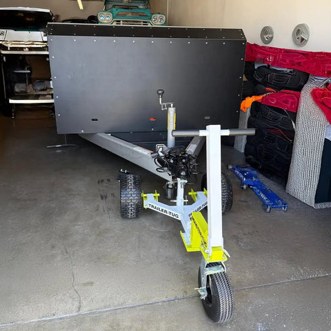 Monster Tug Off-Road Trailer Dolly Moves Boat, RV, Or Utility Trailer With Ease On Sand, Dirt, Gravel, Concrete Hard Surfaces Heavy Metal Frame Manual Mover No Motor Needed Adjustable Ball Mount For Any Tow in a garage with a trailer.