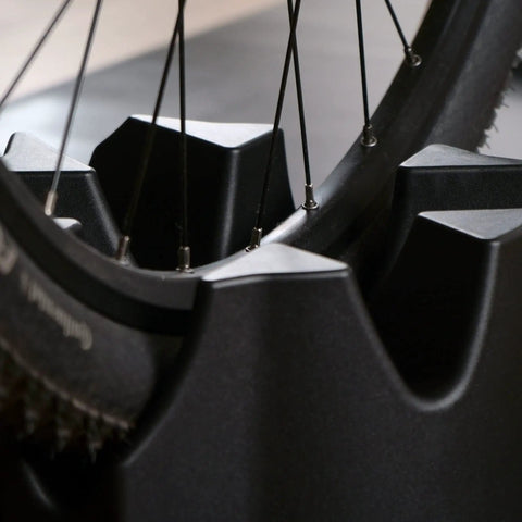 Close-up of front wheel on Front Wheel Riser Block For Indoor Bike Trainers With Three Height Levels Non Slip Front Wheel Stabilizer