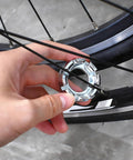 Hand using Eight Way Universal Bicycle Spoke Wrench Tool For Wheel Truing And Tension Adjustment In Hardened Steel