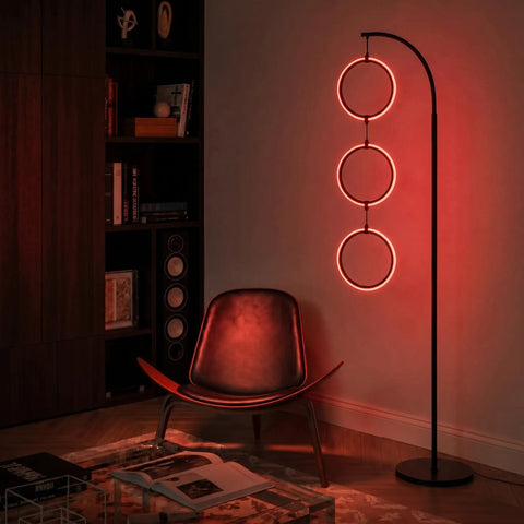 Dope RGB Color Changing Floor Lamp With Arching Three-Ring Pendant in dimly lit living room, red LED glow, sleek black finish