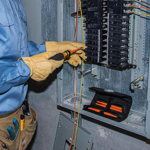 Electrician using Insulated 8 In 1 Screwdriver Set With Interchangeable Blades For Electrical And General Repairs near panel