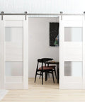 Straight Up No Hassle Sliding Double Barn Doors With Slick Stainless Rail Kit And Heavy Duty Hardware Set For Easy Install In Crisp White Finish Measuring Forty Two By Ninety Six Inches, view showing doors in modern interior.