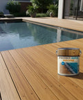 Heavy Duty Water Based Semi Transparent Exterior Wood Stain With UV Defense And Moisture Block For Decks Pergolas Fences And Siding Built To Hold Up Mighty Fine In Warm Chestnut on a wooden deck near a pool.