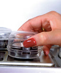 Hand installing Stove And Oven Knob Safety Cover Set L730A Five Count Pack Easy To Install Kid Safe Kitchen Accessory Clear.