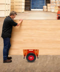 Beefy Heavy Duty Panel Dolly For All Terrain Use With 2 Wheel Slab Design And 10 Inch Solid Wheels, Supports Up To 1100 Lbs, Built Tough For Easy Mobility And Scratch Resistant Iron Construction. Moving large wood panel in warehouse
