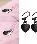 Two Piece Black Heart Shaped Zipper Pull Replacement Kit For Luggage Backpacks Jackets Coats Boots And Clothing Durable Metal Zipper Pulls With Universal Fit For Quick Slider Fix And Easy DIY Repair installed on a pink backpack.