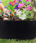 Fabric Raised Garden Bed 2Ft By 4Ft No Fuss Durable Planting Bed filled with flowers and soil, breathable felt material