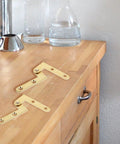 360 Degree Rotating Pivot Hinge Set For Concealed And Secret Doors Seamless Swivel Frame Hardware, gold finish on countertop.