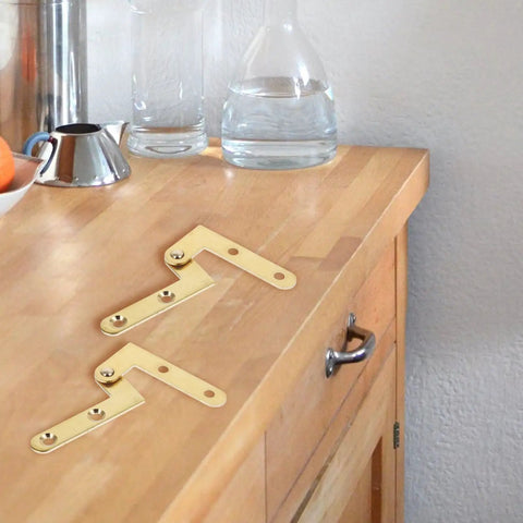 360 Degree Rotating Pivot Hinge Set For Concealed And Secret Doors Seamless Swivel Frame Hardware, gold finish on countertop.