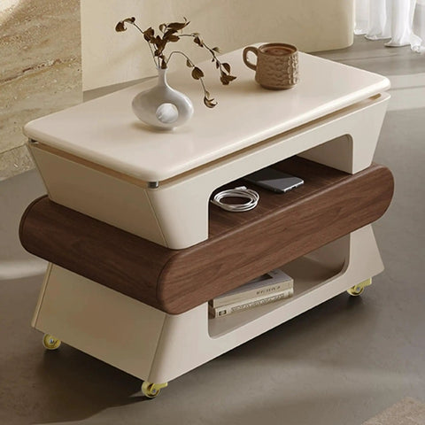 Modern coffee table with two shelves, decorative items on top, and visible yellow casters for mobility on a smooth floor.