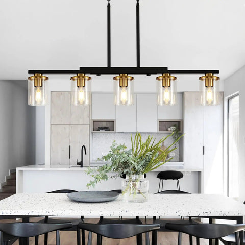 Top Notch Five Light Dining Room Fixture Featuring Clear Glass Shades That Give Any Kitchen Island A Kickin Farmhouse Chandelier Vibe While Building Sweet Warm Ambiance For Gatherings in a modern kitchen setting.