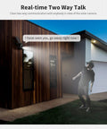 Solar-Powered Wireless Outdoor Security Camera With 360 Degree Pan-Tilt mounted on a house capturing a person at night.