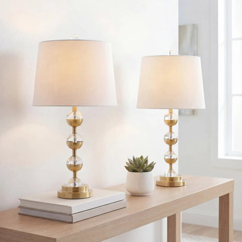 Clear Brass Gold Crystal LED Table Lamps Set of 2 on wooden desk with white linen drum shade and energy saving LED bulbs