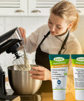 Food Grade Equipment Lubricant For Kitchen Appliances Like Stand Mixers Espresso Machines Beer Kegs Slushies And More Odorless NSF H1 Safe Grease 1 Oz 2 Pack shown next to a stand mixer in use by a person.