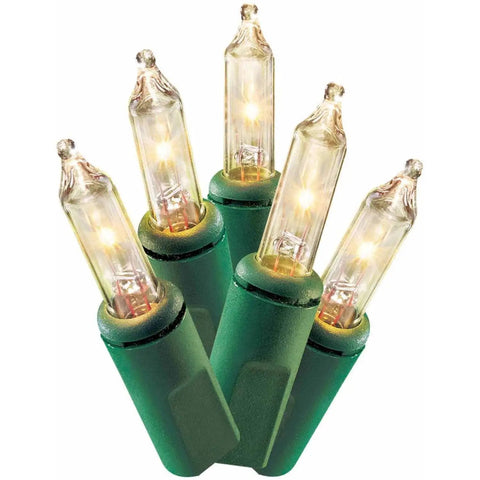 Close-up of Clear Mini Christmas Lights 100 LEDs on green wire, Indoor Outdoor, 2 Pack, showing clear bulbs and green sockets.
