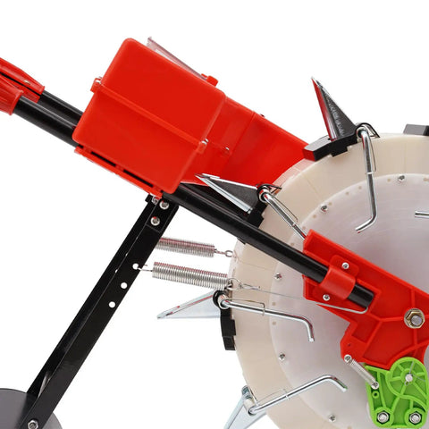 Close-up of the Hand Push Seeder Machine With 10 Spouts, showcasing red planter body, metal supports, and spiked wheels for precise sowing.