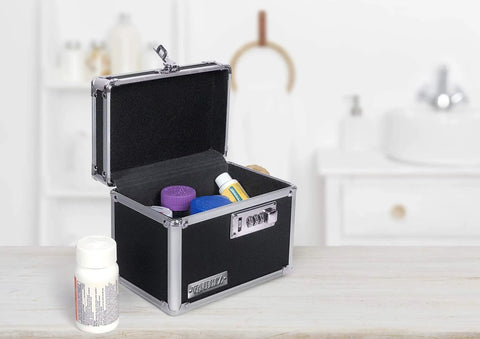 Open black Locking Medicine Box With Combination Lock for Safe Medication Storage showing pills inside, placed on a countertop.
