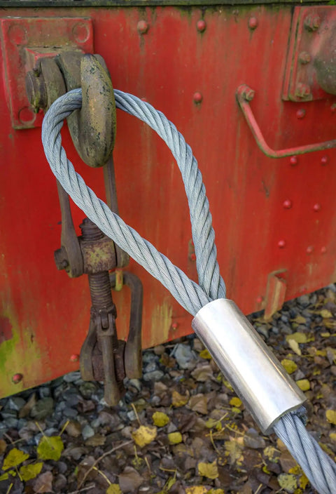 Heavy Duty 7x19 Galvanized Cable Five Sixteenth Inch By Two Hundred Feet attached to rusty metal structure for corrosion resistance