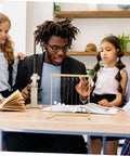 Teacher demonstrating Snake Shape Pendulum Energy Conservation DIY Kit For Hands-On Physics Experiments to students at a table.