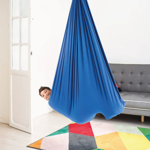 Blue 95 Percent Cotton Sensory Swing For Kids X Large Therapy Swing With Deep Pressure Support For Autism SPD And Anxiety Calming Cozy Swing With 4 Way Stretch Fabric Hardware Included, child in blue indoor swing