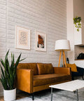 Living room with 20 Pack 115 Sq Ft 3D Faux Brick Panels Peel And Stick White Wall Decor for DIY Friendly Renovation.