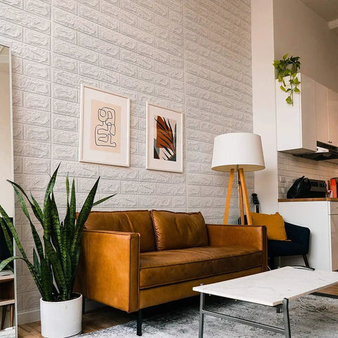 Living room with 20 Pack 115 Sq Ft 3D Faux Brick Panels Peel And Stick White Wall Decor for DIY Friendly Renovation.
