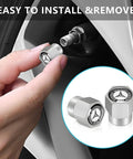 Hand installing Mercedes Benz Tire Valve Stem Cap Covers 4 Pack Aluminum Alloy Metal Wheel Air Caps, silver anodized finish.