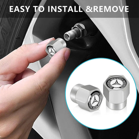 Hand installing Mercedes Benz Tire Valve Stem Cap Covers 4 Pack Aluminum Alloy Metal Wheel Air Caps, silver anodized finish.