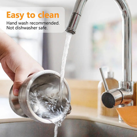 Hand holding 18/8 Stainless Steel Mortar And Pestle Set being washed under a faucet, highlighting easy cleaning of the kitchen tool.