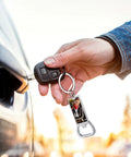 Person holding car key with 10 Pack Sublimation Bottle Opener Blanks Key Rings Aluminum Dope Heat Transfer Metal Bottle Opener Tags