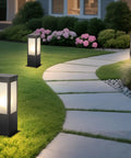Rock Solid 15.75 Inch Outdoor Bollard Path Lights With Knockout Aluminum Frame And Frosted Glass Shade illuminating garden walkway.