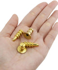 3 gold alignment pins in a hand from the 20 Piece Zinc Alloy Table Leaf Connector Kit Featuring Tight Alignment Pins And Heavy Duty Metal Sleeves For Reliable Extension Table Hardware Upgrades And Quick No Sweat Assembly.